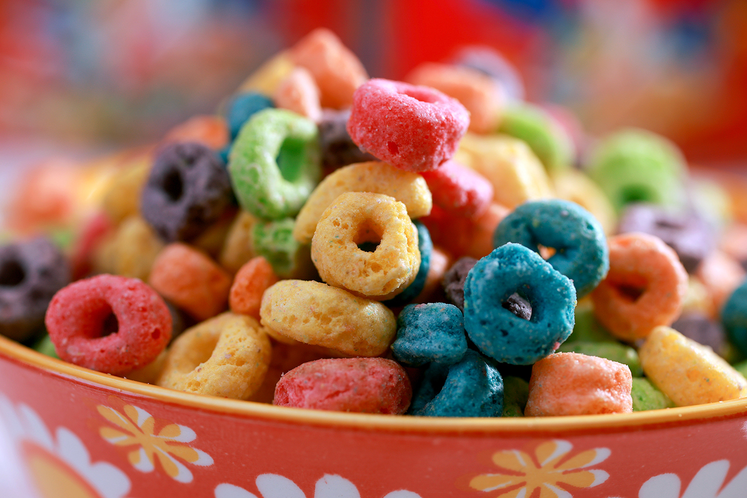 A closeup of brightly colored Froot Loops cereal in a bowl