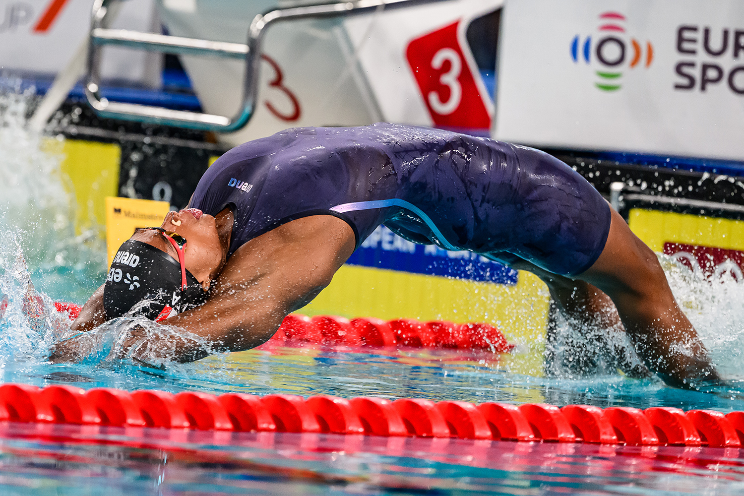 Sara Curtis swims on her back during a competition.