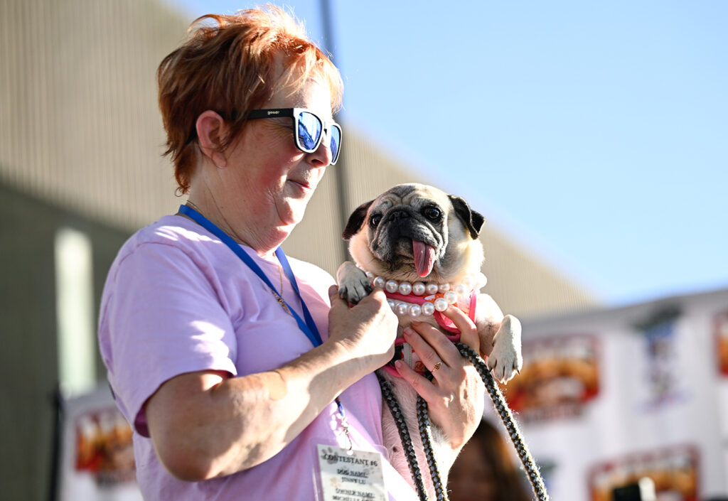 Michelle Grady wears sunglasses and holds her pug, Jinny Lu.