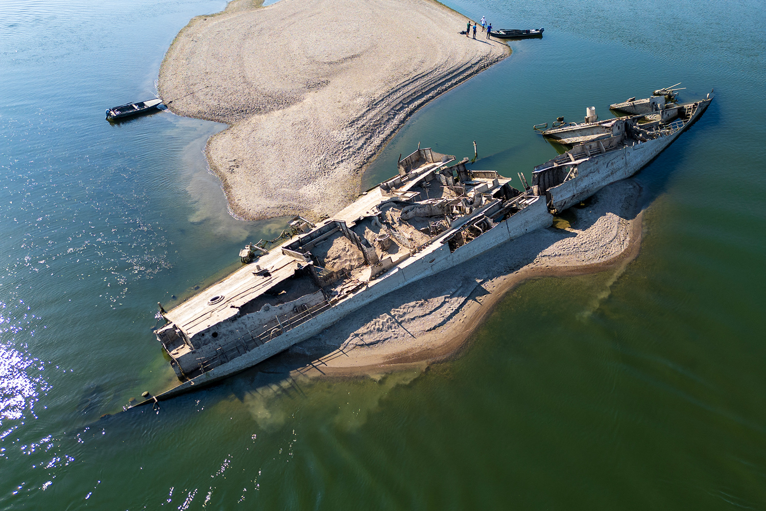 The wreckage of a German World War II ship is shown over an exposed sandbar on the Danube River.