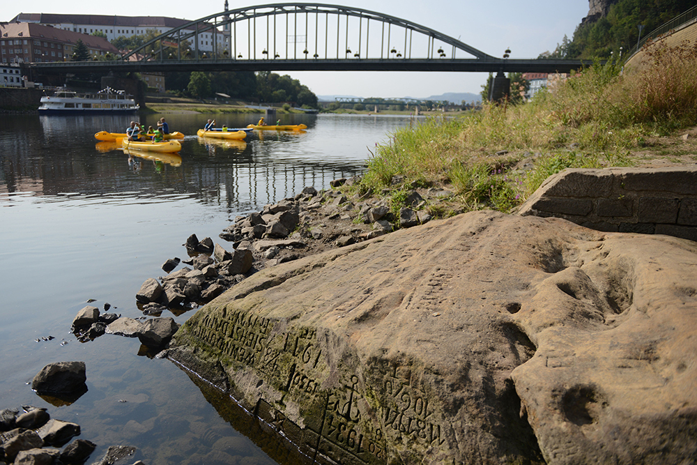 A low water level has revealed a stone with writing etched into it.