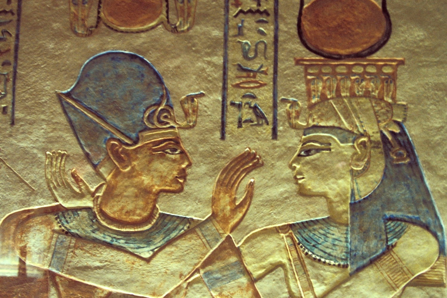 A relief from an ancient Egyptian tomb shows a man and woman facing each other and some hieroglyphics.