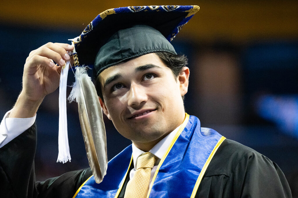 Huumaay Banegas is about to move the feather and tassel on his graduation cap.