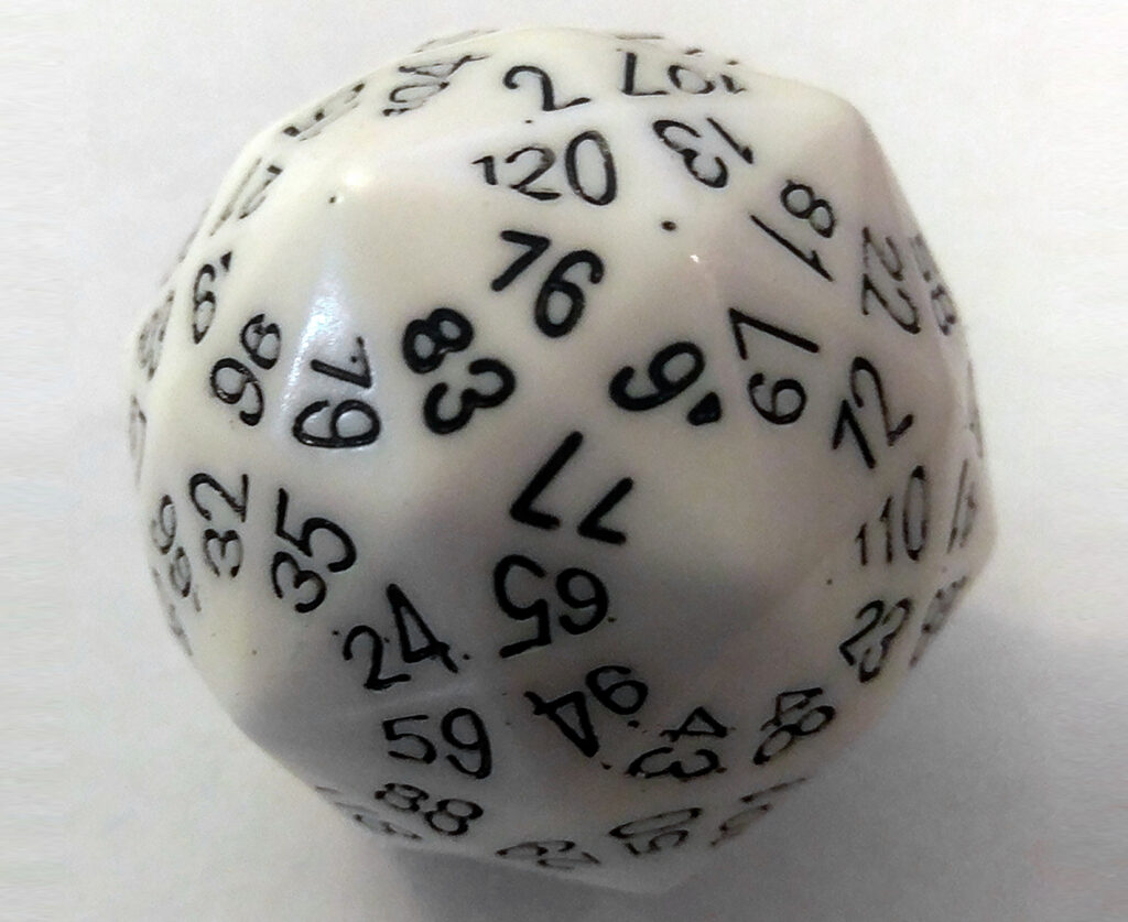 A white 120-sided die with a black number on each side sits on a white background or surface.