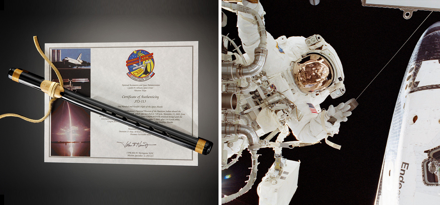 A black flute sits on a certificate showing that the flute traveled into space with John Herrington, and Herrington in a full space suit on a space walk.